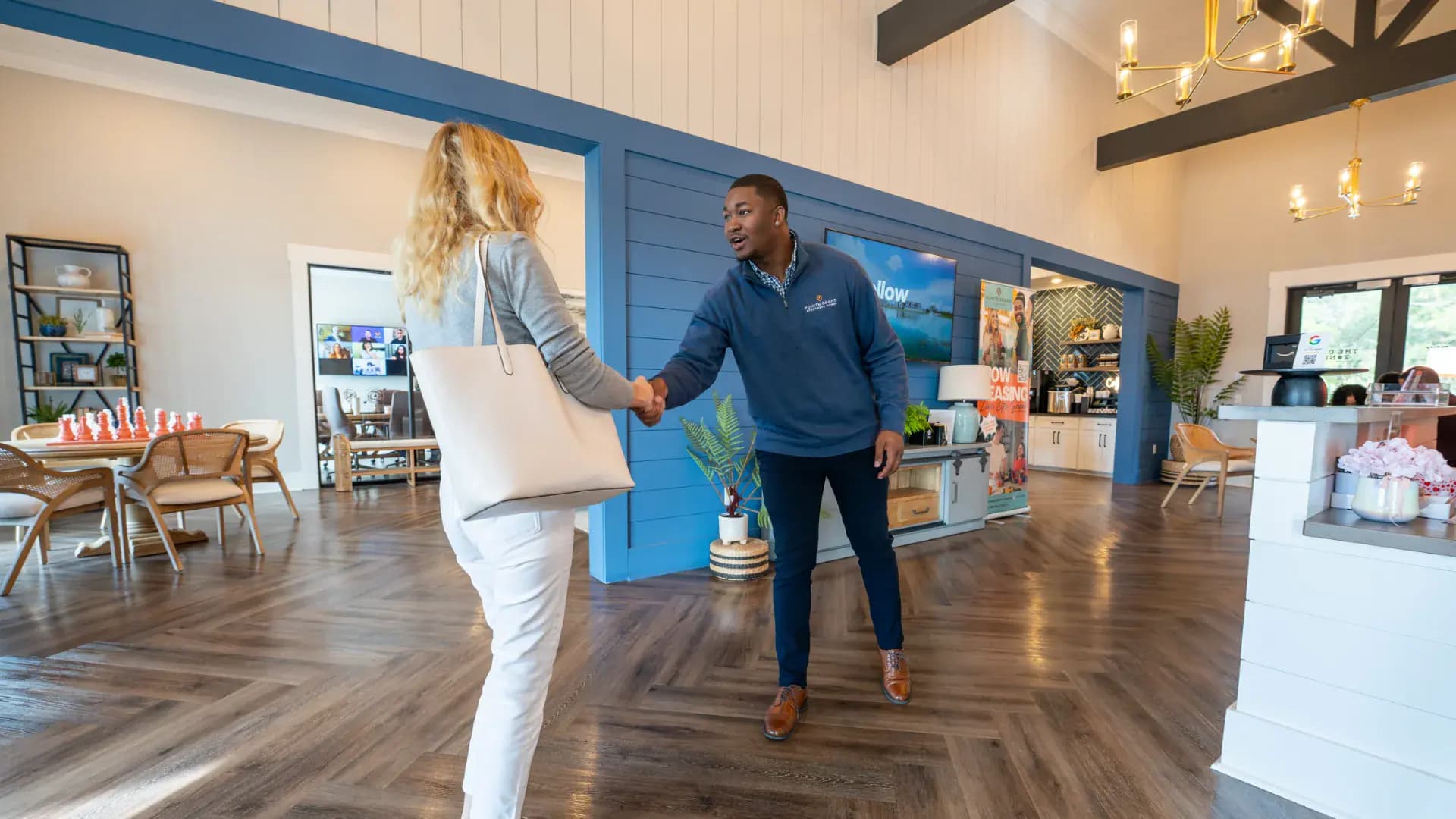 A Pointe Grand leasing team member welcoming a visitor to the clubhouse